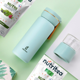 A tall, cylindrical green tea infuser in a light blue color with a screw-on lid. The infuser has a simple, minimalist design and appears to be made of a durable, high-quality material.