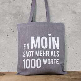 Gray cotton tote bag with white text "Ein MOIN sagt mehr als 1000 worte" (A MOIN says more than 1000 words).
