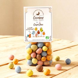  Assorted chocolate-covered nuts and fruits in a variety of colors and shapes, including round, oval, and irregular forms. The product is labeled as "Coq 'n' Choc (cacahuète chocolat dragée)" and is categorized as "Chocolate Covered Fruits".