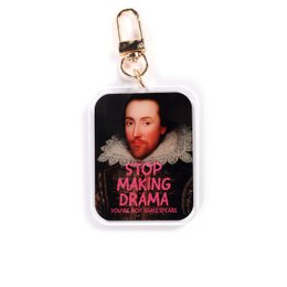  Acrylic keychain with a portrait of a man and the text "Stop making drama" printed on it. The keychain is rectangular in shape and has a gold-colored metal ring for attaching it to keys or bags.