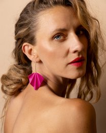  Fuchsia statement earrings with a bold, geometric design.