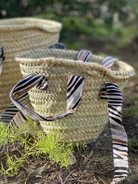 Woven storage basket made of natural fibers, featuring a double handle design and a striped fabric lining. Dimensions: 37 x 30 cm.
