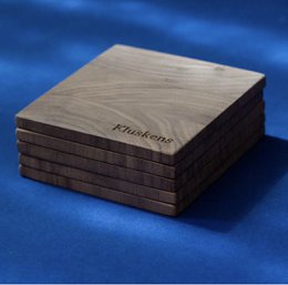 Set of 6 square walnut coasters, each measuring 9x9cm, with a natural wood grain finish.