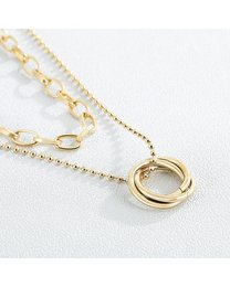 A delicate gold-tone double chain necklace with a circular pendant, perfect for layering or wearing alone. The pendant features a simple, minimalist design that adds a touch of elegance to any outfit.