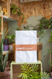  Seedpaper pack containing biodegradable seed paper for planting. Includes various seed types in a white paper package.