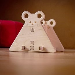 Wooden mouse-shaped toy with and without a slide attachment, designed to help develop motor skills in children.