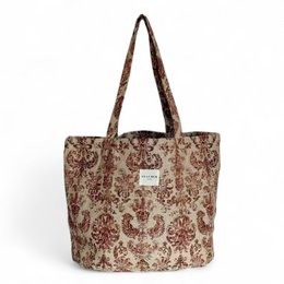  Large brown and beige patterned tote bag with long handles.