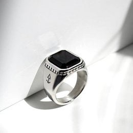 Signet ring with a black stone and silver or gold band, available in various sizes.
