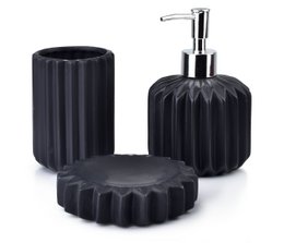 Black bathroom set with soap dispenser, soap dish, and toothbrush holder. Made of ceramic material with a ribbed texture design. Suitable for modern bathroom decor.