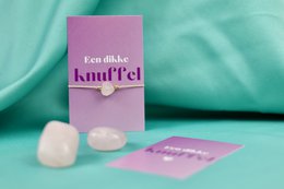  A delicate, pearl-colored bracelet with a soft, plush charm in the shape of a heart, perfect for expressing affection and love.