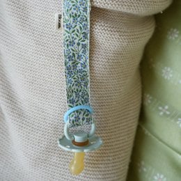 Turquoise floral patterned pacifier clip with wooden ring, soft fabric strap for babies