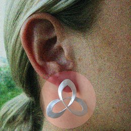 Silver-toned Celtic knot statement earrings with a unique, intricate design.