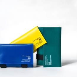 Stylish leather handbag in a variety of vibrant colors including orange, bordeaux, green, and black. Features a sleek, rectangular design with a bold, contrasting trim.