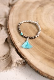 Turquoise charm bracelet with beads and tassel