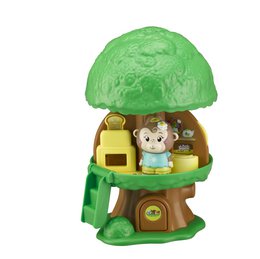  A green, dome-shaped playhouse with a monkey figurine inside. The playhouse has a tree-like design with leaves on top.