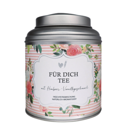 Floral tin canister with "For Dich Tea" label, containing loose leaf tea. Tin has a silver lid and colorful floral design.