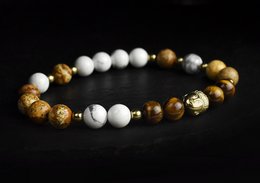 A beaded bracelet with a mix of white, brown, and gold-colored beads.

The BANYAN Bracelet is a charm bracelet featuring a mix of white, brown, and gold-colored beads. The bracelet is available in various sizes ranging from 15cm to 20cm. The beads appear to be made of a combination of materials, including stone and metal, creating a stylish and versatile accessory.