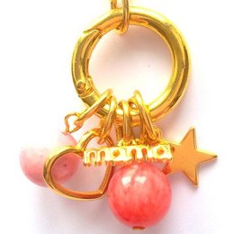 Gold-tone necklace with pink heart and star charms, featuring the word "mama" in a stylized font.