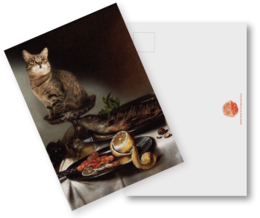 Postcard featuring a cat sitting on a table with various objects, including a cup and saucer, a plate with food, and a vase with flowers.