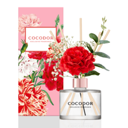  A floral reed diffuser with a red carnation and pink flowers, packaged in a pink box.