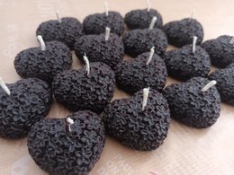 Black heart-shaped beeswax tealight candles, ideal for romantic occasions or home decor.