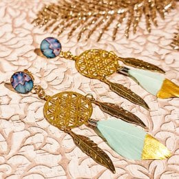 Elegant drop earrings featuring a resin dragonfly charm and wave-shaped mother-of-pearl accents.