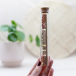 Dried flower tube with "Soon to be mommy & daddy" text. Contains dried flowers and a small glass bottle.