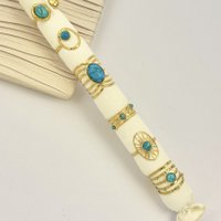 Set of 6 golden turquoise stone rings in stainless steel with cushion offered