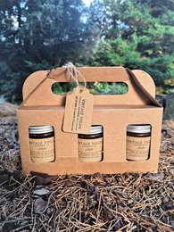 A set of 3 autumn-scented candles in a rustic cardboard gift box. The candles are made of natural soy wax and come in a variety of fall-inspired scents.