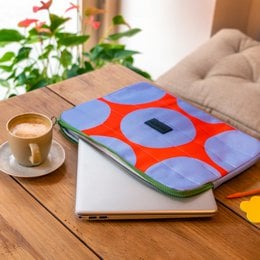 Laptop case in a vibrant blue and red geometric pattern, suitable for protecting and carrying a laptop.