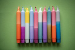 Colorful, cylindrical candles in a variety of pastel shades, including pink, purple, blue, and yellow. The candles appear to be part of a summer collection, as indicated by the "Dippy Summer '24 Collection" title.