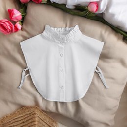  A white women's blouse with a ruffle collar and button closure. The blouse has a high neck and a relaxed, flowing silhouette.