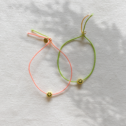 Colorful, flexible bracelet with smiley face charms.