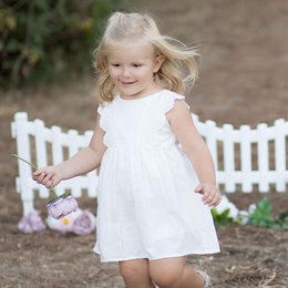 White sleeveless dress with scallop detail, made of organic muslin fabric, suitable for baby girls aged 5-6 years, 6-12 months, 3-4 years, 12-18 months, and 18-24 months.
