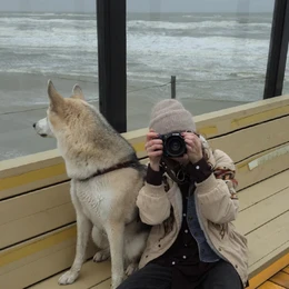 Black leather camera belt with adjustable buckle closure and metal hardware.