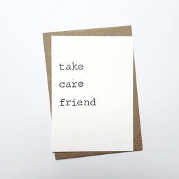 A simple, minimalist greeting card with the text "take care friend" printed on a white background.