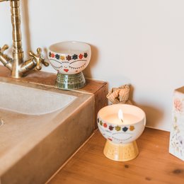 Colorful, ceramic tea light holders with floral and geometric designs. Made of ceramic material, available in yellow and green color variants.