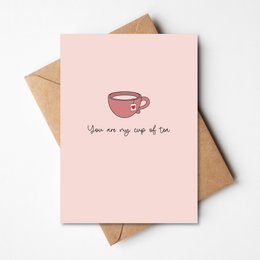 A pink greeting card with a simple illustration of a cup and the text "You are my cup of tea" written on it. The card is suitable for expressing affection or appreciation for someone.