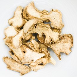 Dried sliced ginger, a seasoning with a warm, spicy flavor. Pieces are irregular in shape and light golden brown in color.