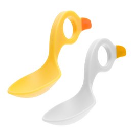 Two colorful plastic spoons for young children. The spoons are in yellow and white colors, designed with a curved shape to make it easier for small hands to grip.