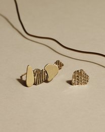 Gold-toned stud earrings with abstract, geometric shapes.