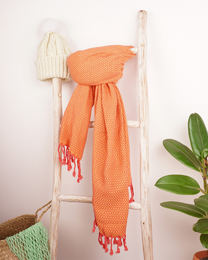 Orange and white Turkish hammam towel with tassels, suitable for beach, spa, or sauna use.
