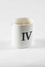  A white candle with the Roman numeral "IV" printed on it. The candle appears to be made of a soft, creamy wax material and is designed for massage or aromatherapy purposes.