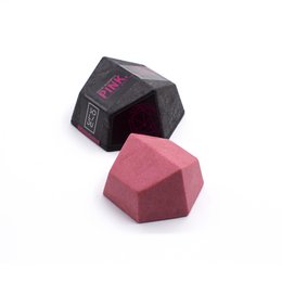 Solid pink shampoo bar with geometric shape.