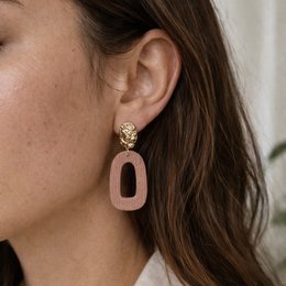  Statement earrings in bronze and black colors with a feather-like design.