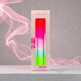Dip dye neon lollipop-shaped candles in vibrant pink, green, and white colors.