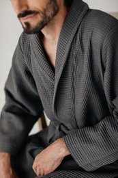 Gray charcoal bathrobe made of soft, absorbent material. Features a waist tie and shawl collar for a comfortable, relaxed fit. Available in sizes S-XXL.