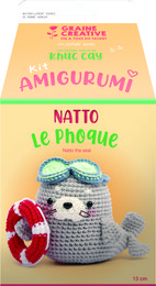 Seal amigurumi crochet kit, includes materials to create a plush seal toy. Soft gray and blue colors, round shape, with a red heart-shaped accessory.