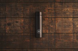 Sleek black thermos bottle with a minimalist design, suitable for hot or cold beverages.