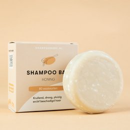 Honey-scented shampoo bar, gentle cleansing for all hair types, natural ingredients, plastic-free packaging.
